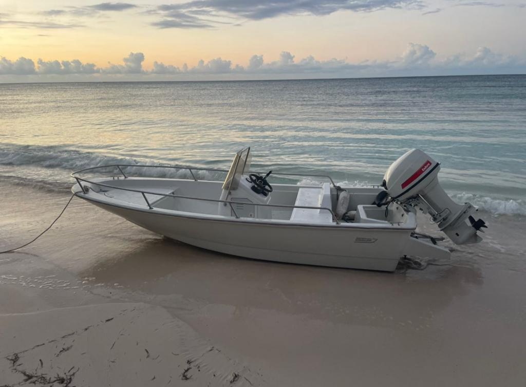 Small boat beached at sunset